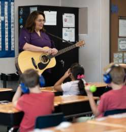 teacher playing the guitar